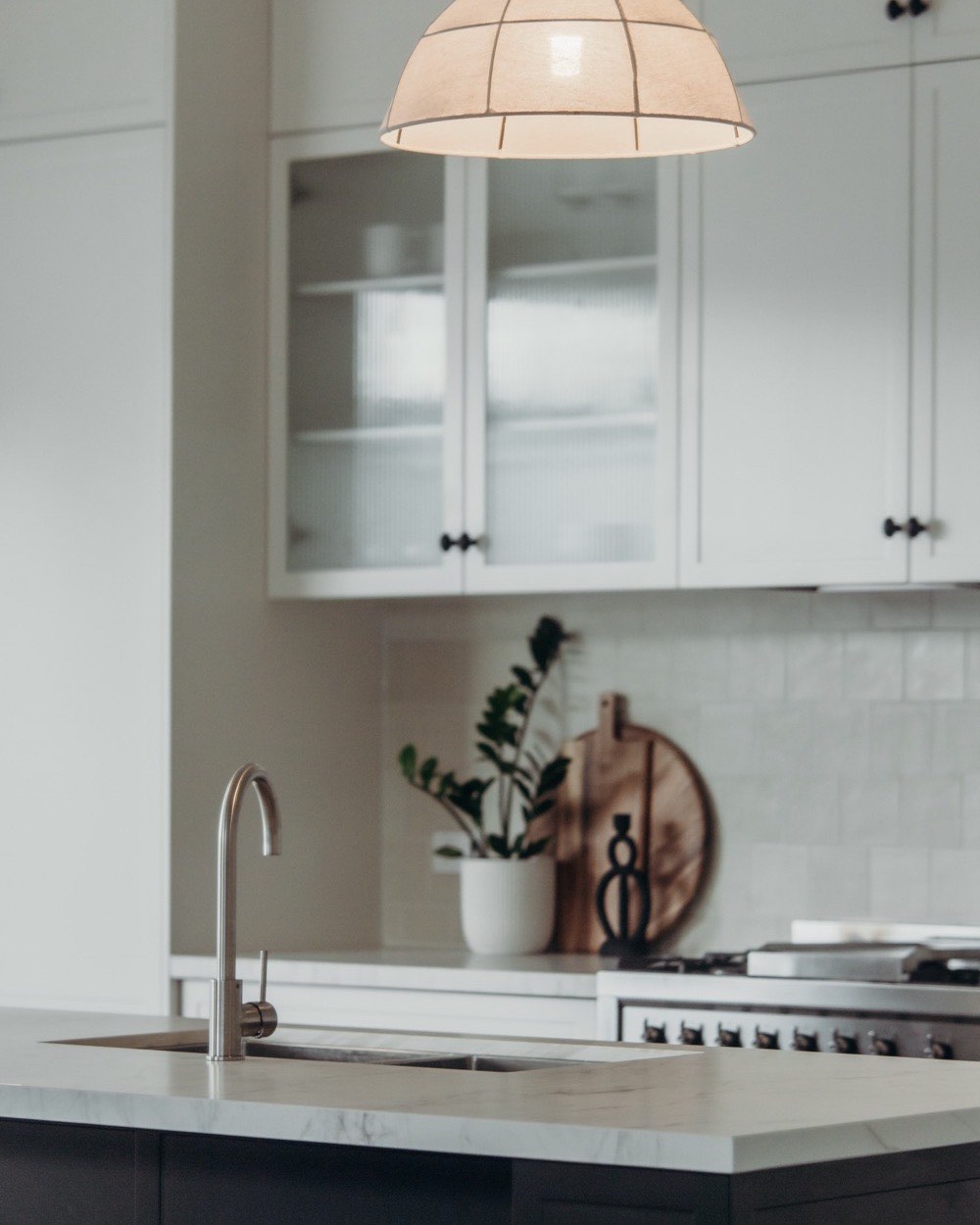 Light mineral surface benchtop over black cabinets in Mayfield