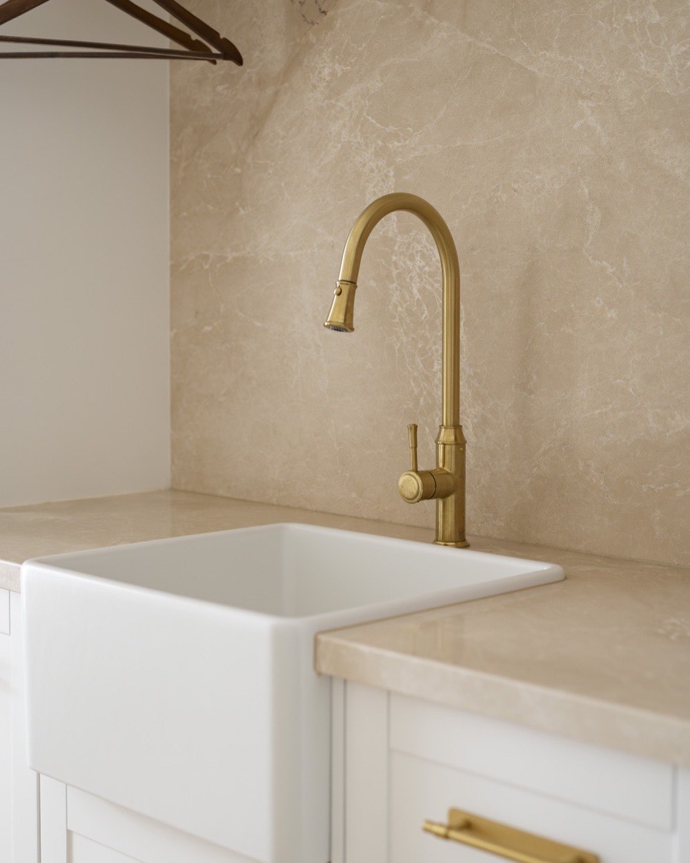 Laundry sink and splashback with a brass tap in Bolwarra