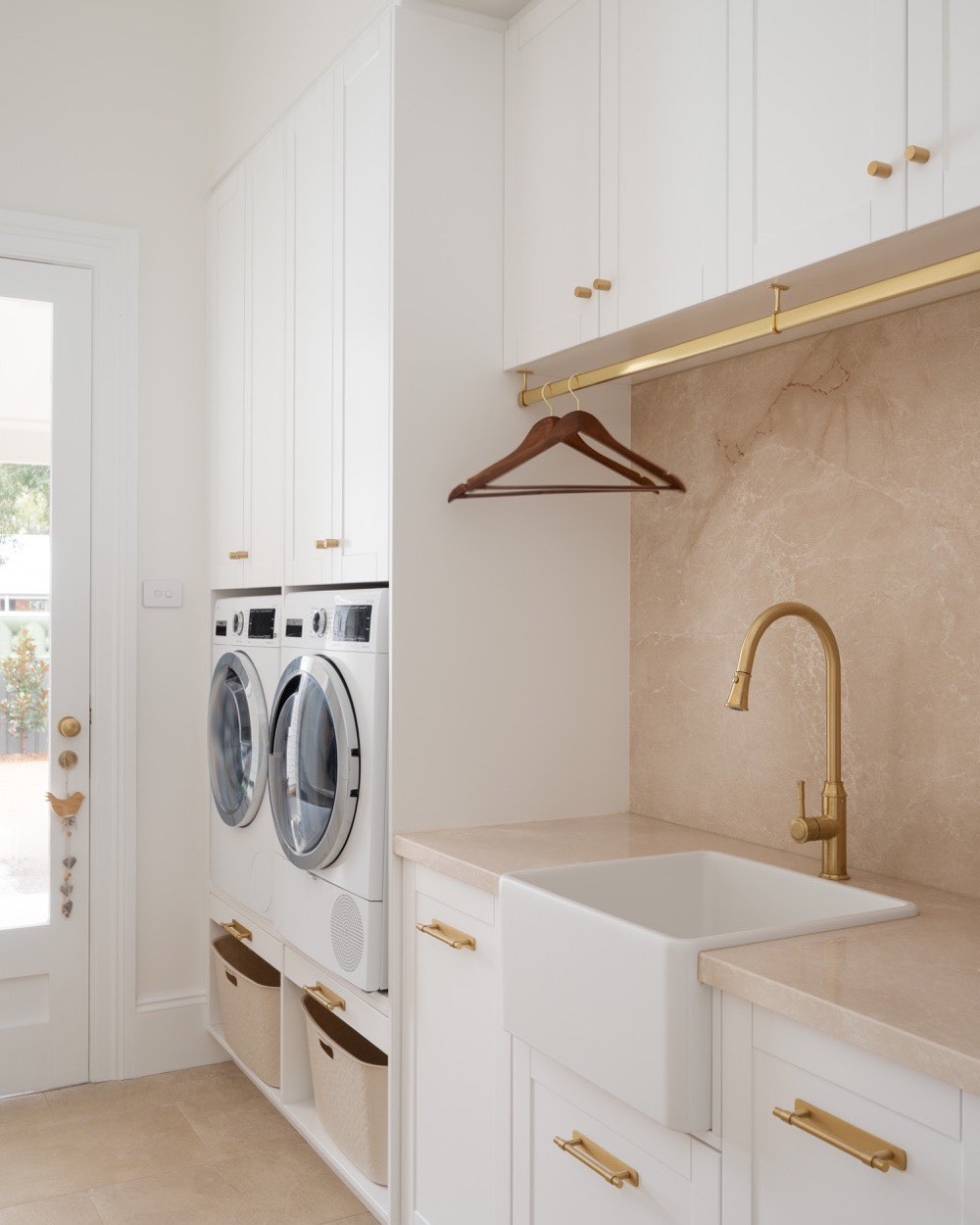 Laundry with a stone benchtop and splashback