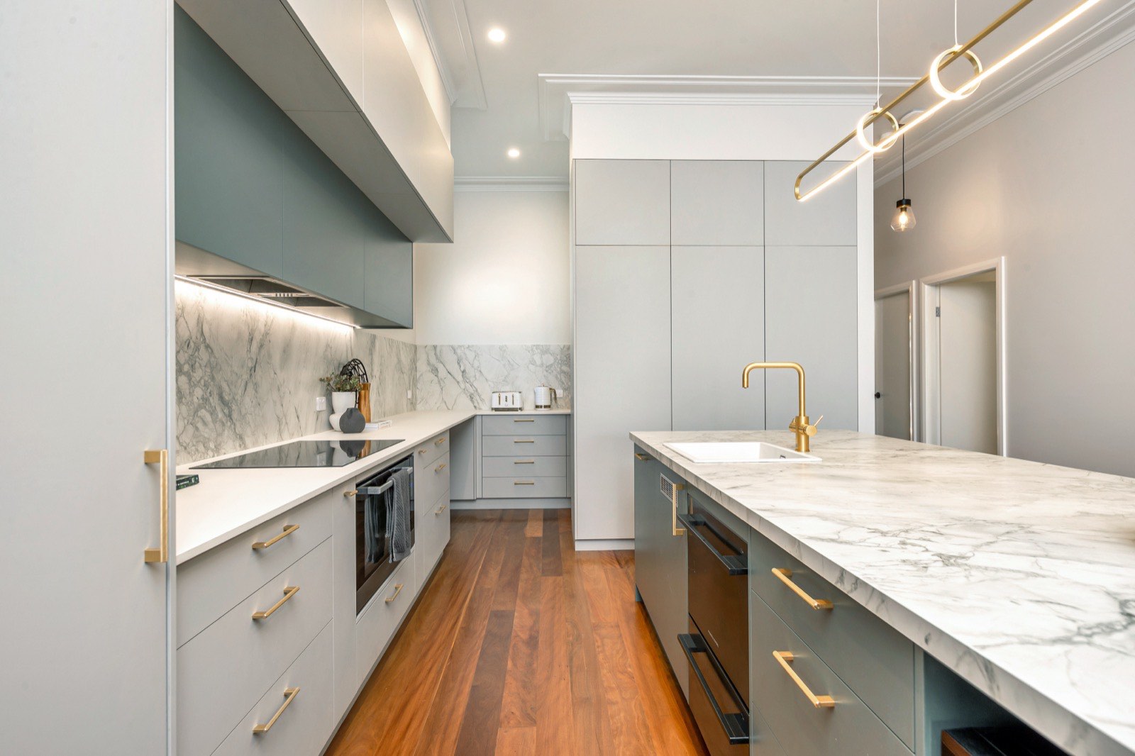 Galley kitchen with Calacatta-look benchtops and sage cabinets on Dawson Street